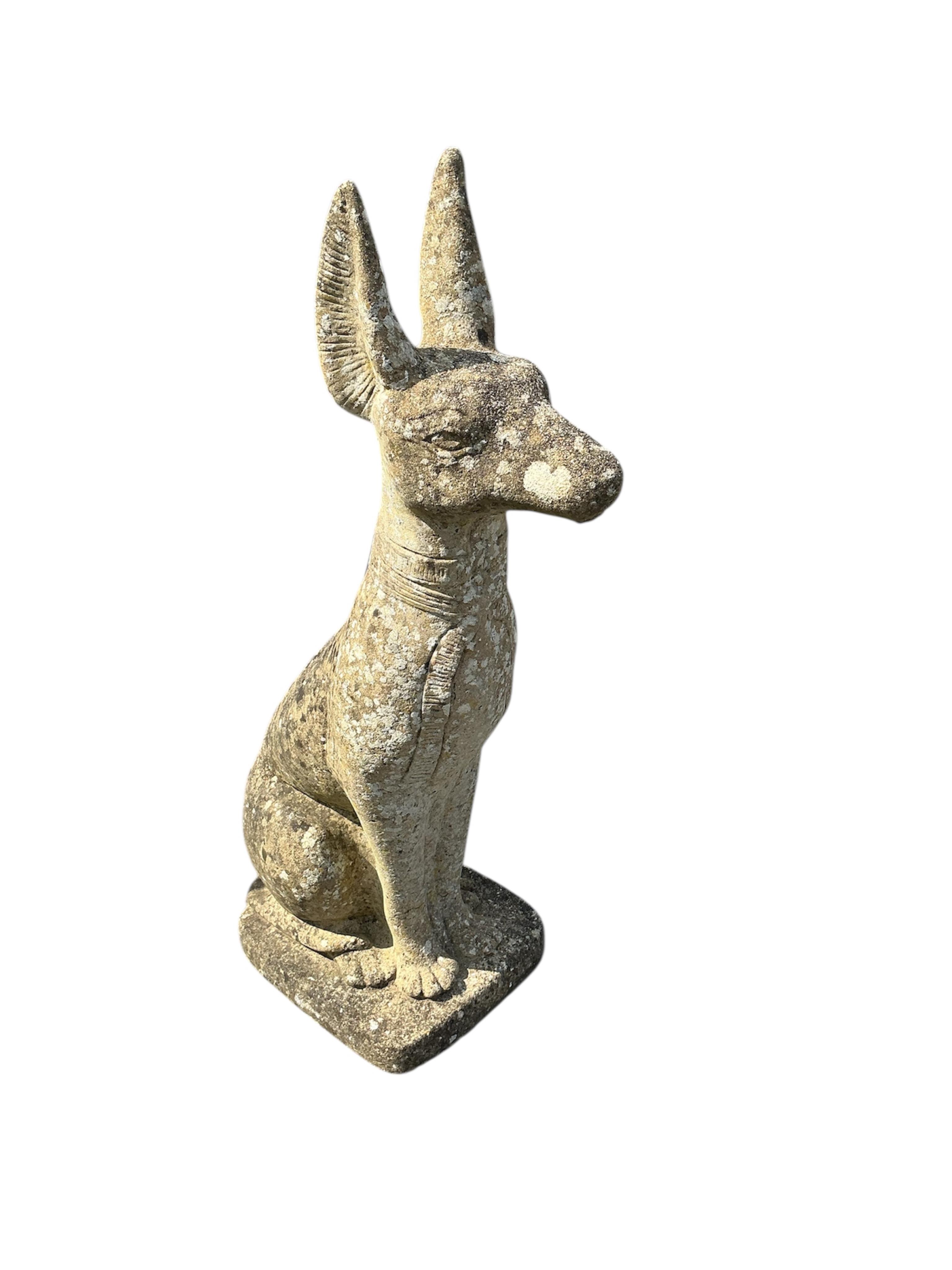 A reconstituted stone seated Anubis garden ornament, height 86cm
